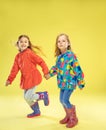 A full length portrait of a bright fashionable girls in a raincoat