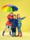 A full length portrait of a bright fashionable kids in a raincoat