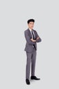 Full length portrait businessman in suit with crossed his arms standing isolated on white background. Royalty Free Stock Photo