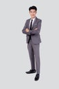 Full length portrait businessman in suit with crossed his arms standing isolated on white background. Royalty Free Stock Photo