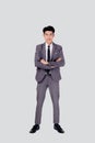 Full length portrait businessman in suit with crossed his arms standing isolated on white background. Royalty Free Stock Photo