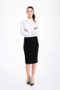 Full length portrait of a businesswoman standing with arms folded Royalty Free Stock Photo