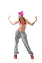 Full-length portrait of carefree girl in gray pants, pink top and hat jumping and dancing. Teen girl hip-hop dancer, over white Royalty Free Stock Photo