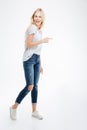 Full length portrait of a casual woman pointing finger away Royalty Free Stock Photo