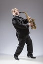Full Length Portrait of Caucasian Mature Concentrated Saxophone Player