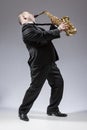 Full Length Portrait of Caucasian Mature Expressive Saxophone Player Playing the Instrument