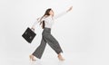 Full length portrait of caucasian young businesswoman running with retro suitcase isolated over white background Royalty Free Stock Photo