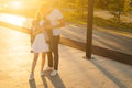 Full length portrait of charming young couple in love kissing hugging in summer evening on background of warm sunlight. Royalty Free Stock Photo