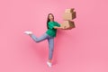 Full length portrait of cheerful crazy person arms hold pile stack packages isolated on pink color background