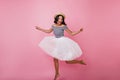 Full-length portrait of cheerful latin girl in long skirt. Joyful caucasian lady in straw hat jumpi Royalty Free Stock Photo