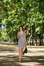 Successful woman in the park. Pretty girl with a cocktail on a natural background. Walking outside concept. Copy space. Royalty Free Stock Photo