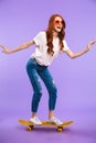 Full length portrait of a cheerful young girl in hat Royalty Free Stock Photo