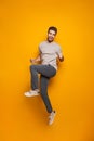 Full length portrait of a cheerful young man jumping Royalty Free Stock Photo