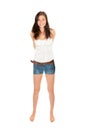 Full length portrait of a cheerful young woman wearing short blue jeans and a summer top