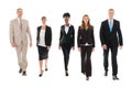 Confident Business Team Walking Against White Background Royalty Free Stock Photo