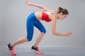 Full length portrait of a confident focused sportswoman getting ready to start running while posing Royalty Free Stock Photo