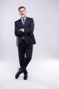 Full length portrait of confident mature businessman in formals standing isolated over white background. Royalty Free Stock Photo