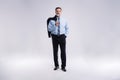 Full length portrait of confident mature businessman in formals standing isolated over white background.