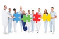 Confident Medical Team Holding Jigsaw Pieces Royalty Free Stock Photo