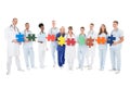 Confident Medical Team Holding Jigsaw Pieces Royalty Free Stock Photo