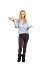 Full length portrait of confused teenage girl holding books in o Royalty Free Stock Photo