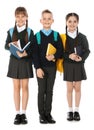 Full length portrait of cute children in school uniform with backpacks and books on white Royalty Free Stock Photo