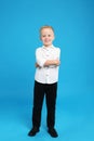 Full length portrait of cute little boy on blue background Royalty Free Stock Photo