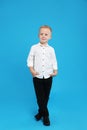 Full length portrait of cute little boy on blue background Royalty Free Stock Photo