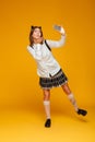 Full length portrait of a cute teenage schoolgirl in uniform Royalty Free Stock Photo
