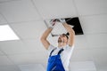 Electrician On Stepladder Installs Lighting To The Ceiling Royalty Free Stock Photo