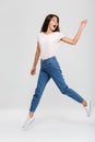 Full length portrait of an excited pretty asian woman jumping