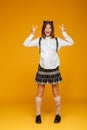 Full length portrait of an excited schoolgirl in uniform Royalty Free Stock Photo