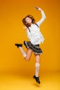 Full length portrait of an excited teenage schoolgirl in uniform Royalty Free Stock Photo