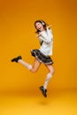 Full length portrait of an excited teenage schoolgirl in uniform Royalty Free Stock Photo