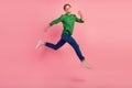 Full length portrait of excited young man in shirt jumping running fast enjoy isolated over pastel color background Royalty Free Stock Photo