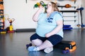 Exhausted Overweight Woman in Gym