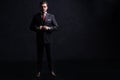 Full length portrait of a fashion male model over black background. Looking at camera. Royalty Free Stock Photo