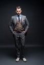 Full length portrait of a fashion male model over black background. Looking at camera. Royalty Free Stock Photo