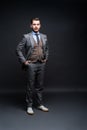 Full length portrait of a fashion male model over black background. Looking at camera. Royalty Free Stock Photo