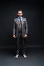 Full length portrait of a fashion male model over black background. Looking at camera. Royalty Free Stock Photo