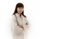 Full length portrait of female asian doctor stands with arms folded looking at camera smiling. Young woman with long hair in white Royalty Free Stock Photo