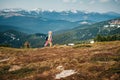 Female hiker in a unicorn costume in mountains in Spring