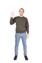 Full length portrait of friendly young man, smiling broadly, waving palm raised up, greeting friends, saying hello. Carefree Royalty Free Stock Photo