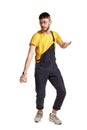 Full-length portrait of a funny guy dancing in studio isolated on white background. Royalty Free Stock Photo