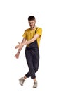 Full-length portrait of a funny guy dancing in studio isolated on white background. Royalty Free Stock Photo