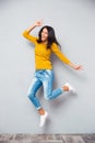 Full length portrait of a funny woman jumping Royalty Free Stock Photo