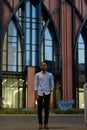 Full length portrait of handsome black African businessman outdoors in city at night Royalty Free Stock Photo