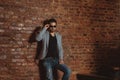 A full length portrait of a handsome stylish man posing in loft studio interior. Fashion for men Royalty Free Stock Photo