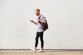 Full length handsome young man walking with cell phone Royalty Free Stock Photo