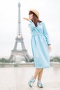 Full length portrait of happy cheerful young woman in blue dress enjoying wonderful view of Eiffel tower in Paris Royalty Free Stock Photo